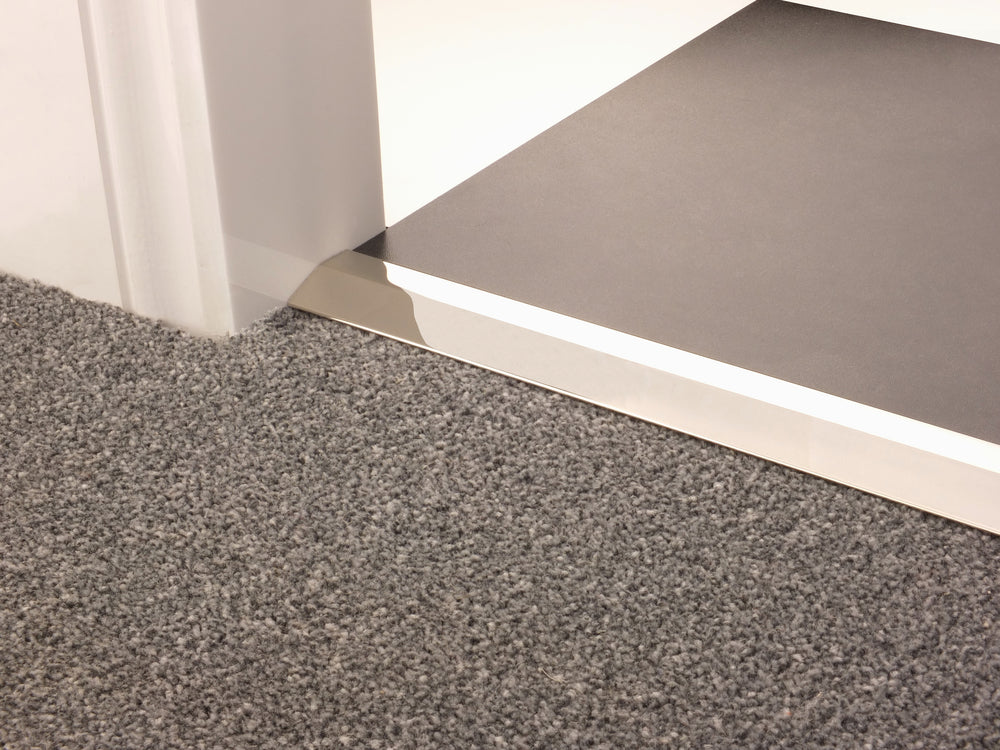 Stairrods Premier Carpet Ramp Flooring Trim in brushed metal finish transitioning grey carpet to grey vinyl floor