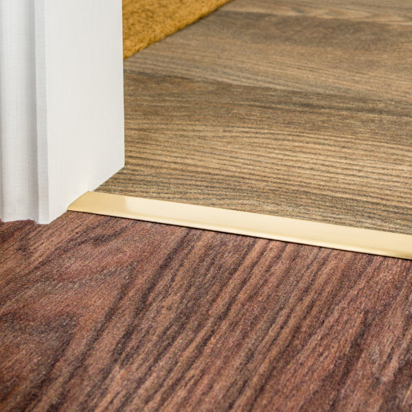Stairrods Premier DoubleZ Flooring Trim in polished metal finish separating two wood effect floorings
