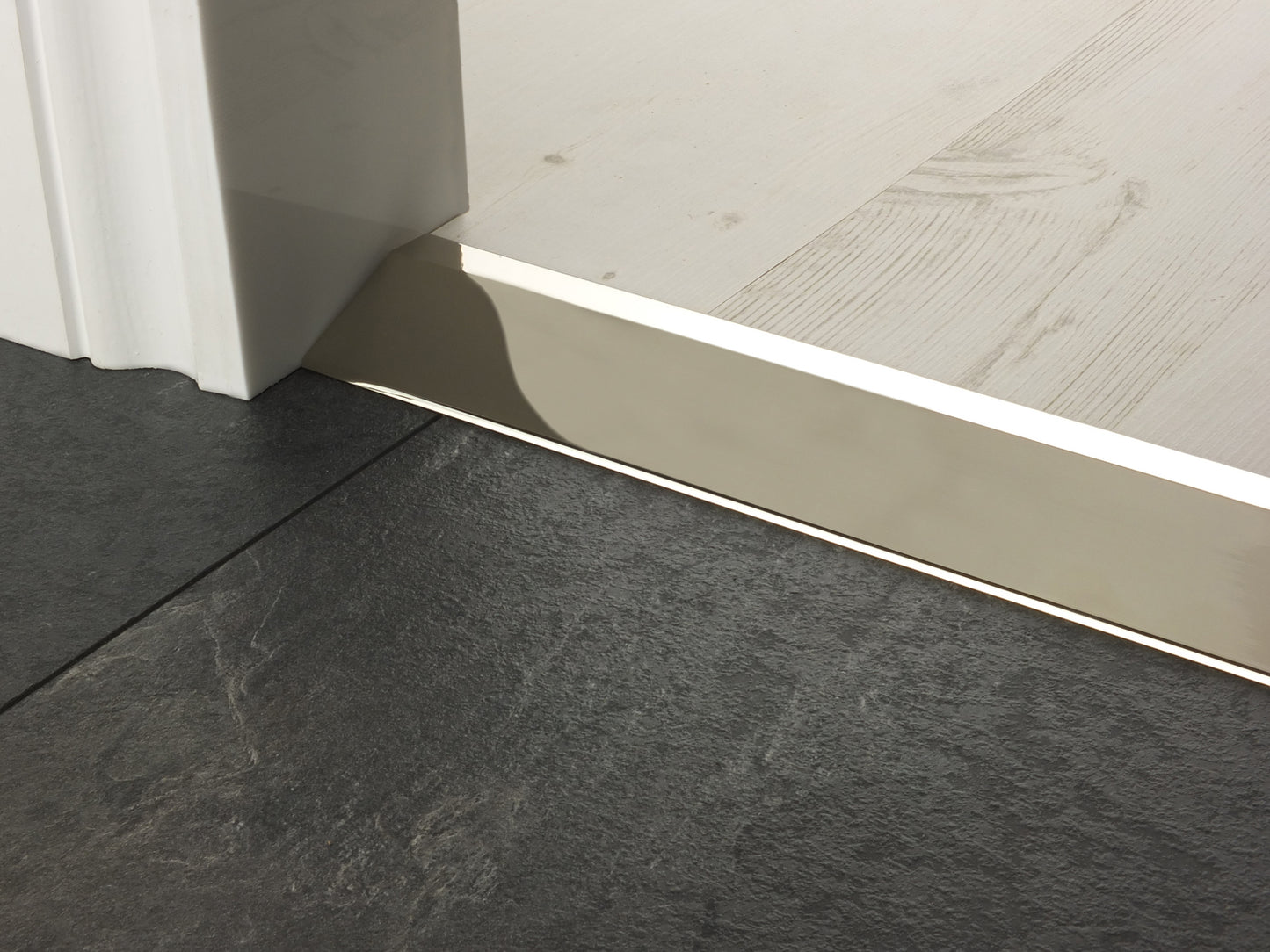 Stairrods Premier Ramp Flooring Trim door bar transitioning between dark tile and light wood flooring