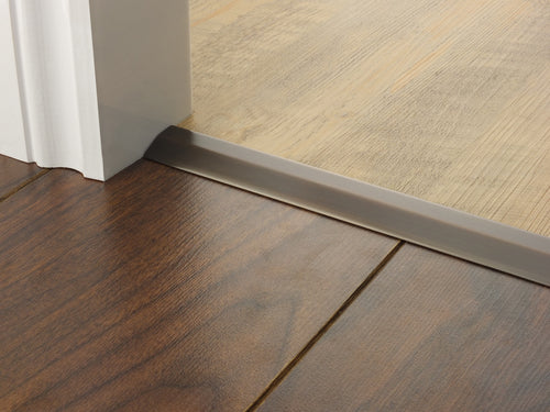 Stairrods Premier Two Way Ramp Flooring Trim installed between dark and light wooden floors at a door threshold