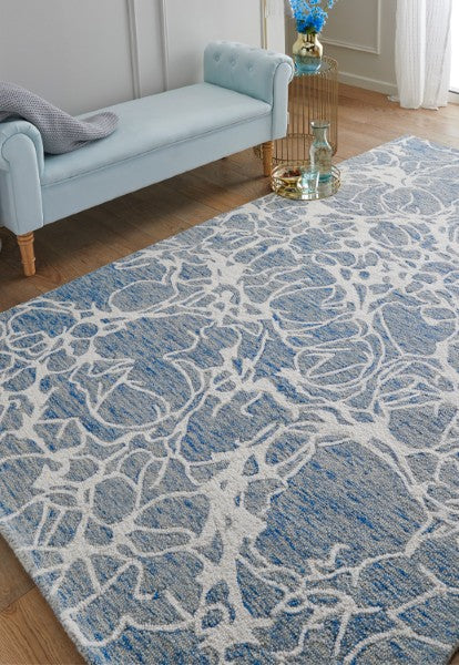 Melrose Interiors rug from The Hampton Collection featuring a blue and white floral pattern in a modern living room