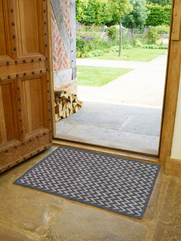 Turtle Mats Cotswold Weave Door Mat placed inside doorway on stone floor with garden view