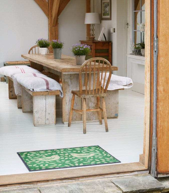Turtle Mats LOOTING FRUITS Design Indoor Mat with green leaf and fruit pattern at wooden dining room entrance