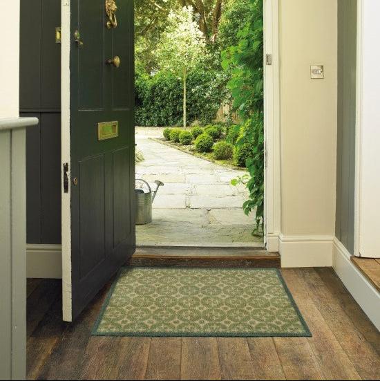Turtle Mats Parterre Design Door Mat placed at wooden floor entrance with open black door