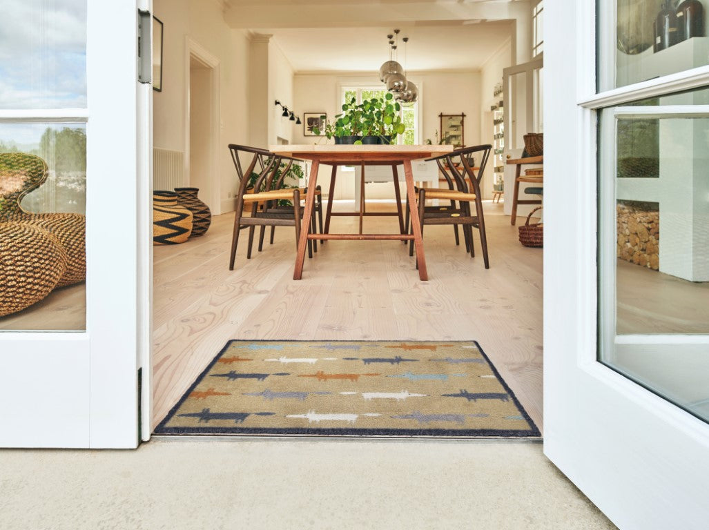 Turtle Mats Running Mr Fox Design floor mat placed at the entrance of a bright dining room