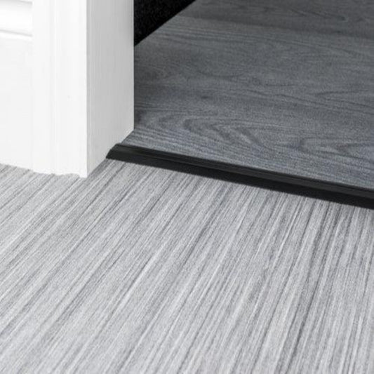 Stairrods Premier Posh Flooring Trim in black metal separating grey wood and laminate flooring