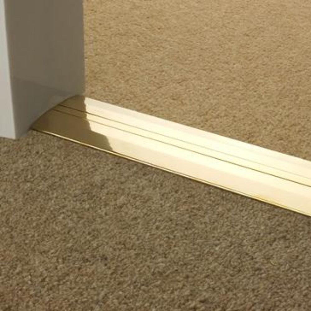 Gold metal flooring trim installed between two carpeted rooms featuring Stairrods Premier Posh Flooring Trim