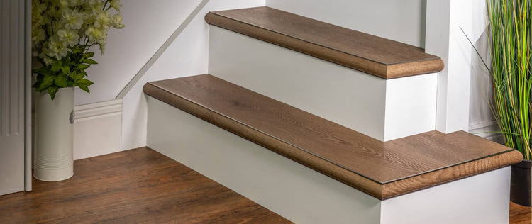 Close-up view of wood grain texture in light brown LVT and laminate flooring panels