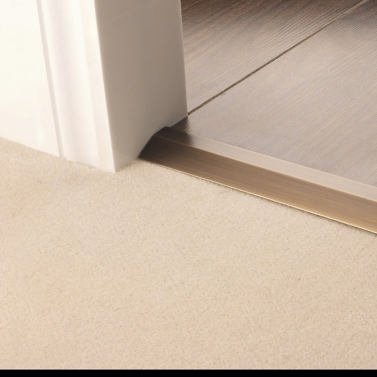 Stairrods Premier Carpet Ramp Flooring Trim in bronze finish linking beige carpet to wooden floor