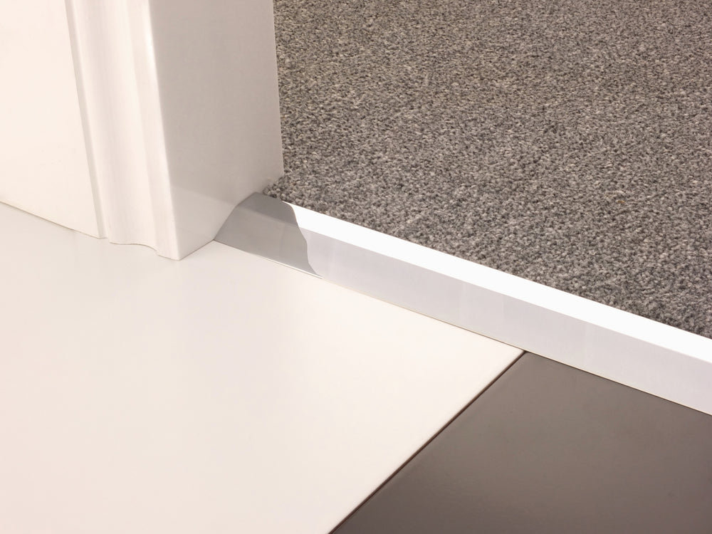 Stairrods Premier Carpet Ramp Flooring Trim installed between grey carpet and white tile floor next to doorframe