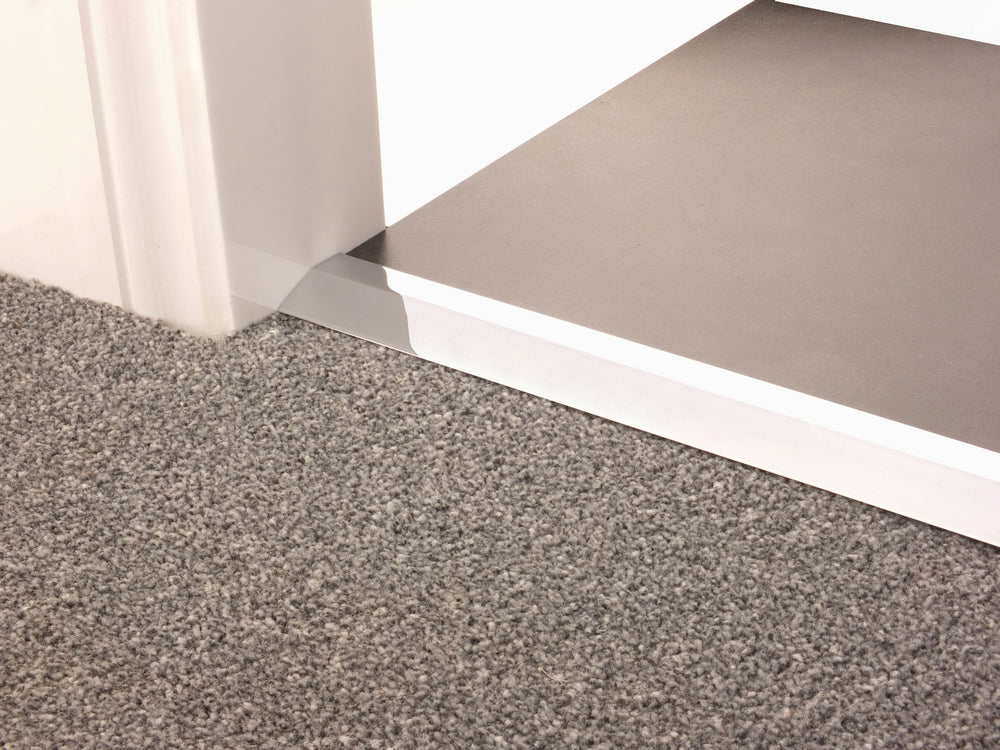 Stairrods Premier Carpet Ramp Flooring Trim installed between grey carpet and brown flooring providing smooth transition