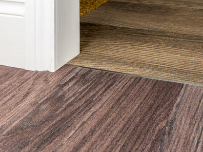 Stairrods Premier Dividers installed between two different wood-effect flooring types for a seamless transition