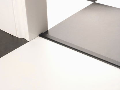 Stairrods Premier Floating Vinyl Edge door bar in black placed between white and dark grey flooring