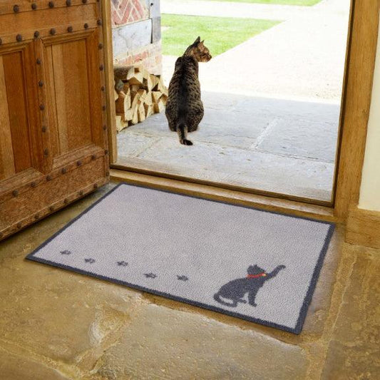 Turtle Mats Cat Walk Design floor mat with grey background and black cat silhouette at wooden door entrance