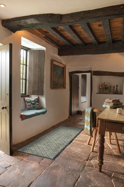 Turtle Mats Parterre Design Door Mat placed on rustic stone floor in a country-style hallway