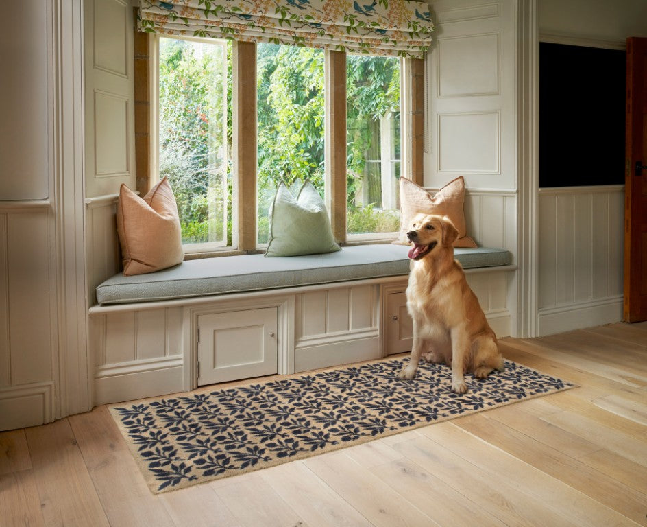 Turtle Mats - ROSEHIP Design floor mat with floral pattern placed in front of window seat with dog sitting on it