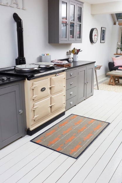 Turtle Mats Running Mr Fox Design floor mat placed on white wooden kitchen floor near cream cooker