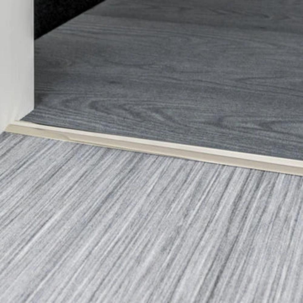 Stairrods Premier Posh Flooring Trim in metal finish separating two wood-effect floors