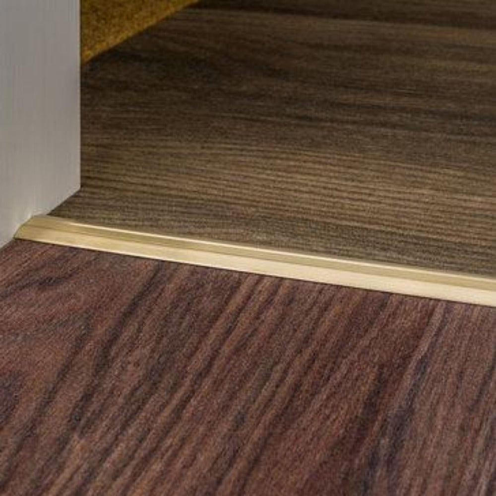 Stairrods Premier Posh Flooring Trim in metallic finish installed between two wood flooring surfaces