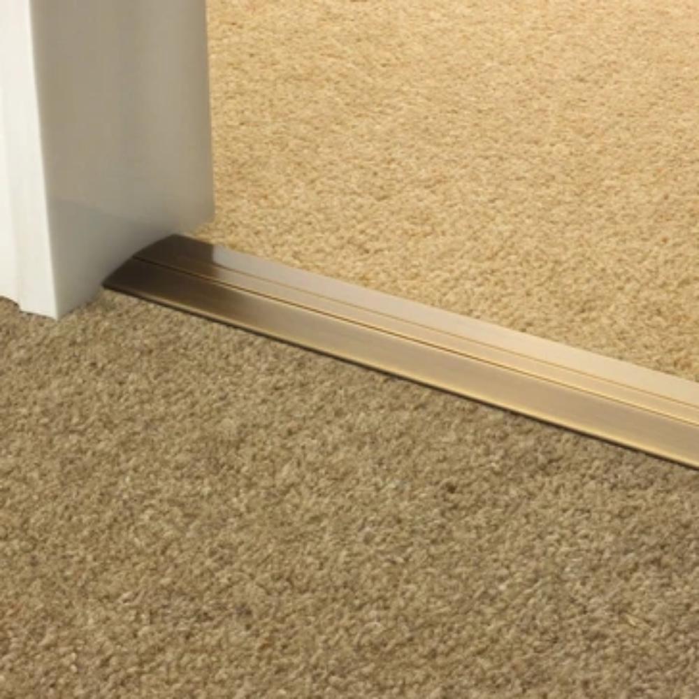 Stairrods Premier Posh Flooring Trim in metal finish installed between two beige carpet sections