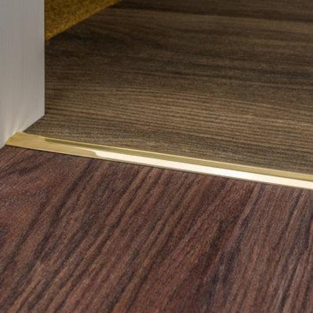 Stairrods Premier Posh Flooring Trim in polished gold finish installed between two wooden floors